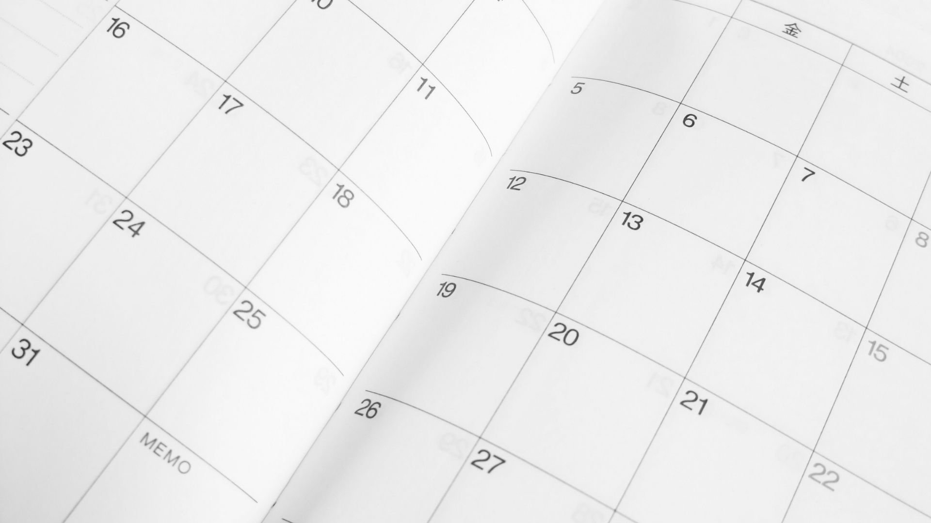 Close-up of calendar pages with numbered dates, including a dumpster memo section on bottom left